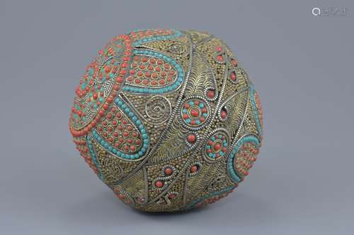 A large Tibetan decorative ball with hammered white metal design with turquoise and faux coral stone