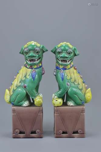 A pair of Chinese vintage painted polychrome porcelain foo dogs. 25.5cm tall (2)