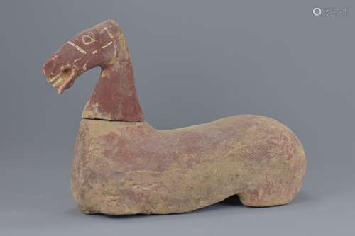 A Chinese Han Dynasty (206BC - 220AD) painted pottery seated horse with separate head. 40cm length