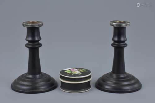 A pair of ebony wood candle sticks with silver mounts. London 1922 P&B. Together with a porcelain bo