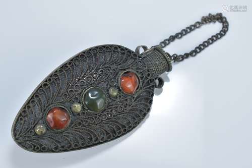 A Tibetan white metal filigree snuff bottle with coloured stone inserts and cover on chain. 8.5cm le