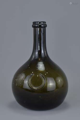 An early 19th century Onion-Shaped dark green glass wine bottle with rounded body. 21cm tall