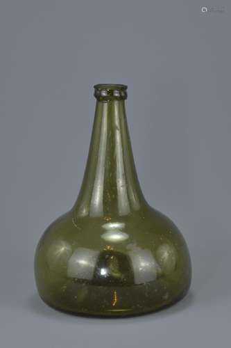 An early 19th century Onion-Shaped green glass wine bottle with rounded body and flat base. 20cm tal