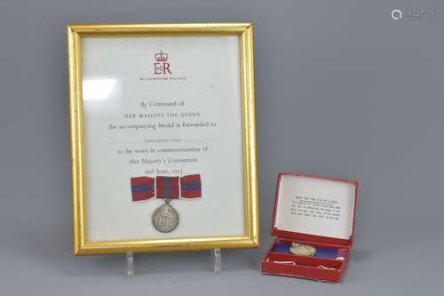 A framed and glazed medal in commemoration of Her Majesty's Coronation 2nd June, 1953. Together with