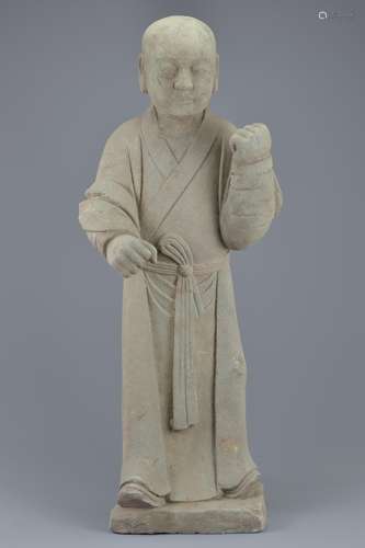 A Chinese Ming dynasty or later carved standing stone figure of a young attendant. 74cm tall