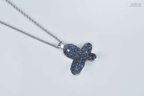 A 14K white gold necklace (stamped 585) with sapphire and single round brilliant cut diamond butterf