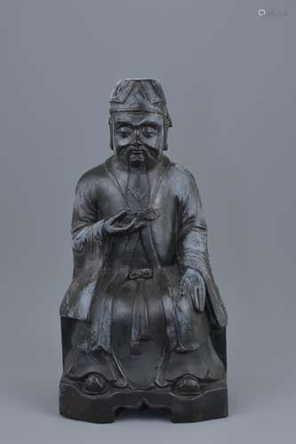 A Chinese 19th century bronze figure of the 'God of Wealth' holding an Ingot with inscription to bac