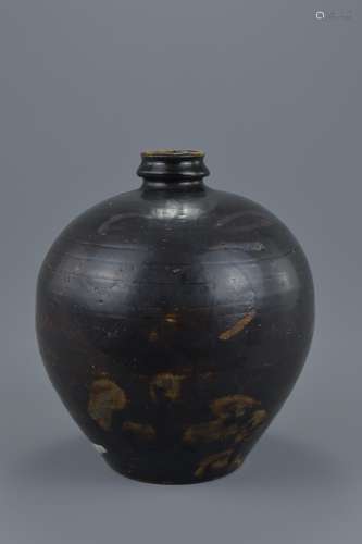 A Chinese black glazed Jin / Song dynasty globular jar with shallow neck decorated with painted leav