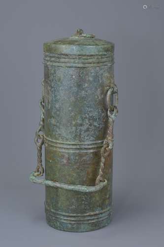 A Chinese Han Dynasty (206BC to 220AD) bronze cylindrical wine vessel with cover and carry handle on