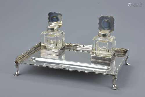 An English Sterling silver inkstand on four legs and with two glass pots with silver covers. Hallmar