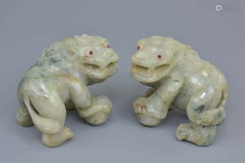 A pair of 19/20th century Asian possibly Chinese carved jadeite lions with ruby eyes. 7cm x 8cm (2)