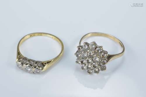 An 18ct gold ring with three diamonds together with one other ring