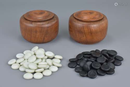 A set of Chinese Huanghuali Boxes and Covers together with games pieces, 11cms diameter (2)