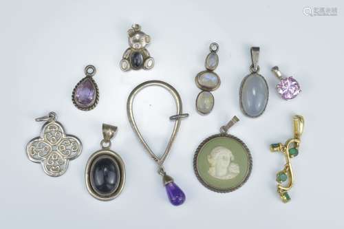 A group of nine various pendants to include a Wedgwood Silver mounted Cameo pendant, a silver bear p