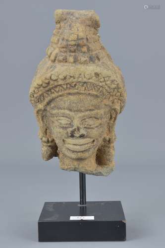 A 19th century possibly Cambodian sandstone carving on display stand. Head 15cm x 9cm