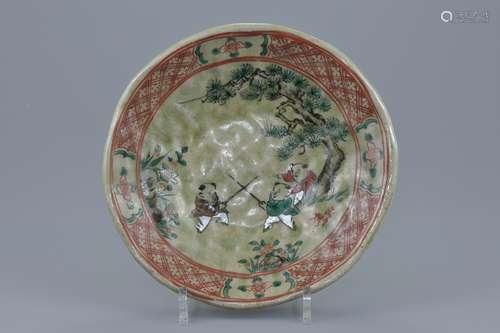 A Japanese celadon glazed pottery dish painted decoration of children playing. Makers signature in r