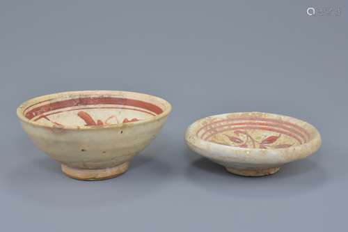 A Chinese Song dynasty Cizhou ware pottery bowl with painted green and red peony decoration together