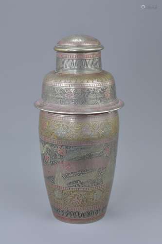 A vintage Anglo-Indian brass cocktail shaker with heron decoration. 21cm tall