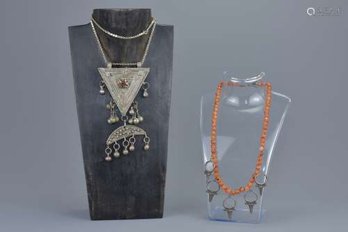 A Yemini white metal prayer box necklace together with a carnelian beaded necklace with white metal