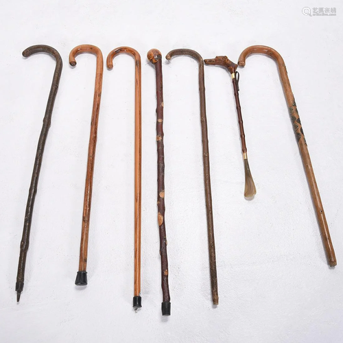 Six Wood Walking Canes and a Carved Figural …