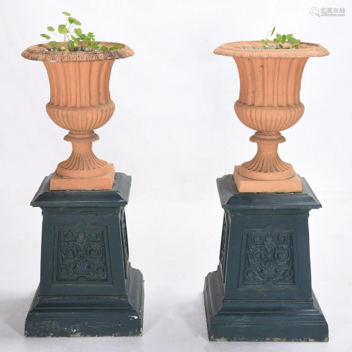 Pair of Outdoor Urns on Cast Iron Plinths.