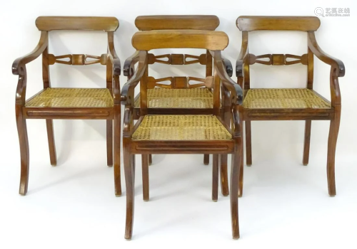 A set of four padouk wood open armchairs with …