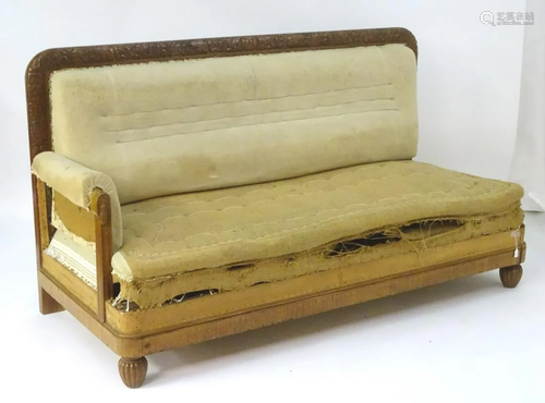 An early / mid 20thC daybed / sofa with a carved…