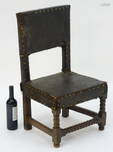 A 17thC childs chair with leather upholstery and b…