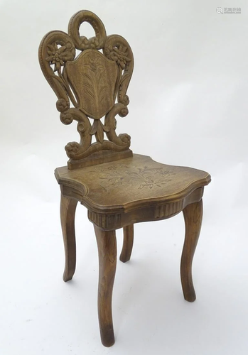 A mid 20thC music box in the form of a chair, the b…