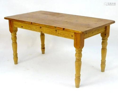 An early 20thC pine kitchen table with a rectangu…