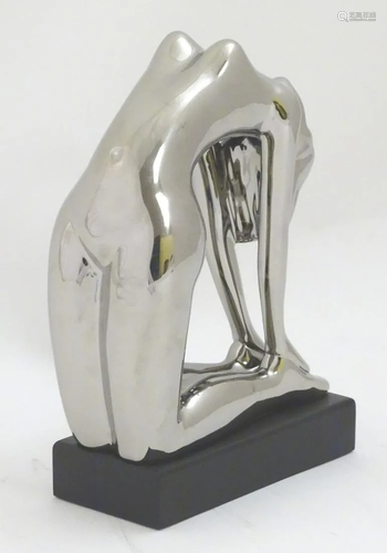 A 21stC sculpture of a nude woman with a chrome…