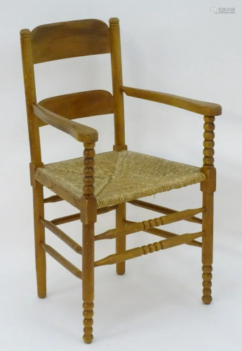An Arts & Crafts open armchair with ladder back st…