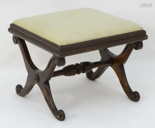 A 19thC mahogany stool with a drop in seat above a