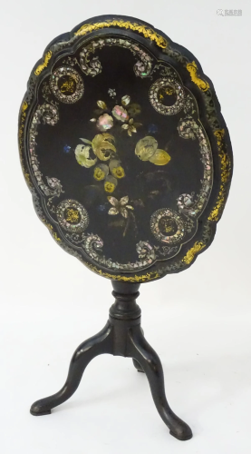 A 20thC ebonised occasional table with a shap…