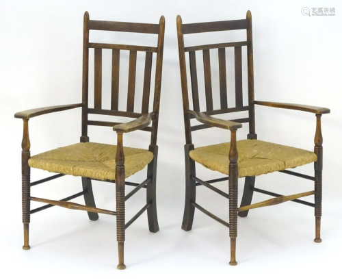 A pair of Arts and Crafts open armchairs with s…