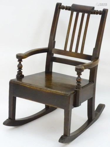 A late 18thC fruitwood rocking chair with unusual