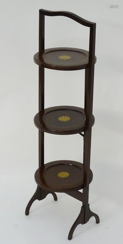 An early 20thC mahogany folding cake stan…