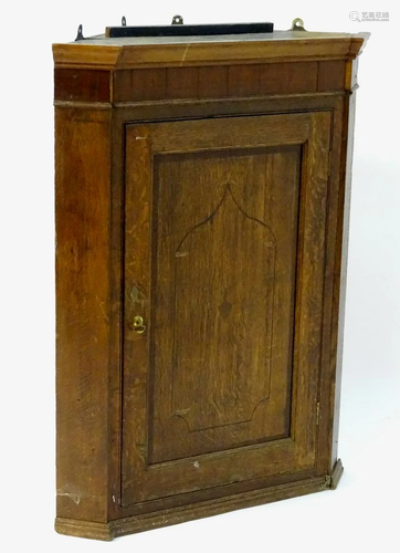 An 18thC oak corner cupboard with a crossbande…