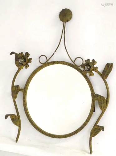 A circular mirror / girandole adorned with floral