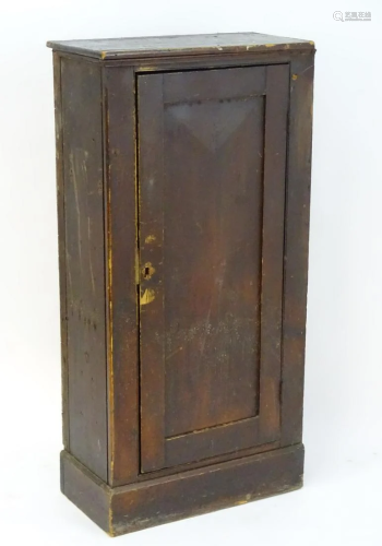 An early 20thC pine cupboard with a moulded re…
