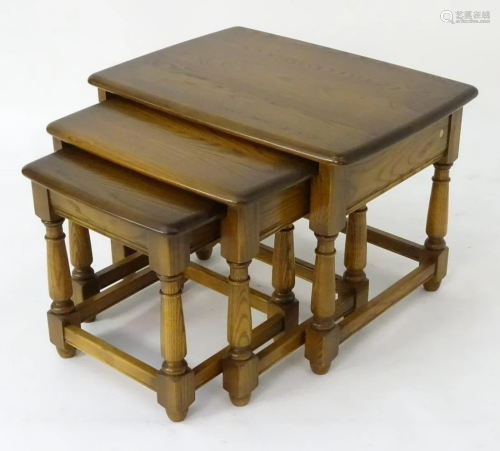 A 21stC ash nest of three tables by Ercol, with