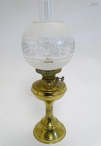 A 20thC oil lamp with brass base with column stan…