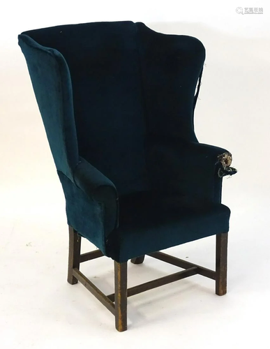 A 19thC wingback armchair with scrolled arms …