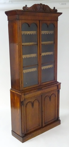 A late 19thC mahogany bookcase with a carved pedi…