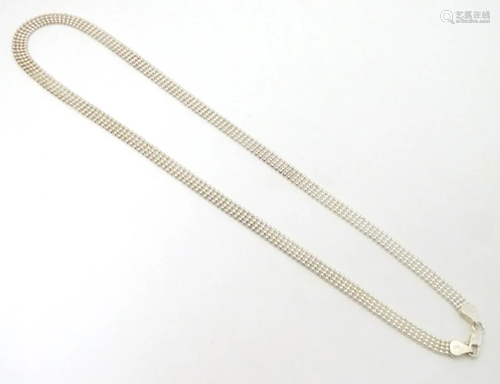 A silver necklace of flat link form. Approx 18'' long