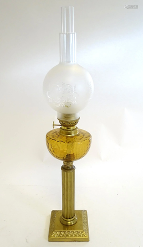 An oil lamp with brass square base supporting a col…