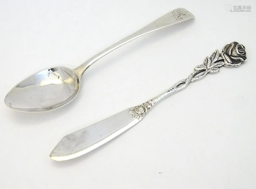 A .800 German silver butter knife with rose decorat…