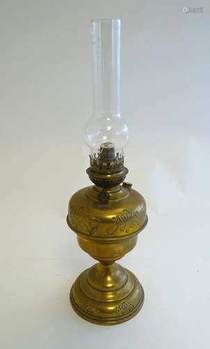 A 20thC oil lamp the brass stand with scroll