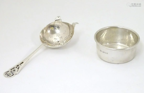 A silver tea strainer and stand / bowl. Hallmarked