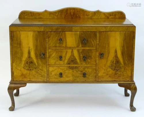 A mid 20thC walnut sideboard with a shaped up …